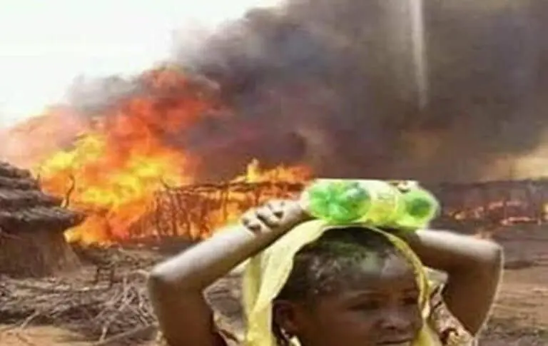 A young girl looks at her village set ablaze in West Darfur 768x485 1